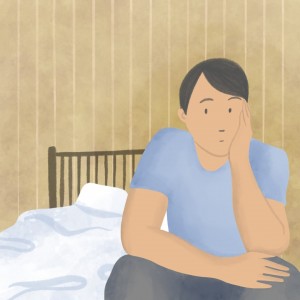 Man sitting on end of a bed